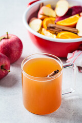 Homemade hot apple cider in glass cup. Autumn or winter warming drink.
