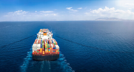 Panoramic back view of a cargo ship carrying containers for import and export, business logistic...