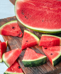 Close up of tasty sliced fresh watermelon on a wooden chopping board