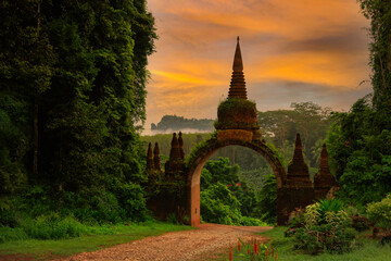 The ancient Thai arch of a Buddhist temple in southern Thailand on a mountain in a big forest during a quiet and beautiful morning - 530082376
