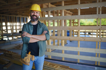 Portrait of construction worker smiling and looking at camera, diy eco-friendly homes concept.