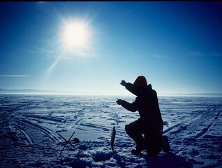 An ice angler landing a pike 