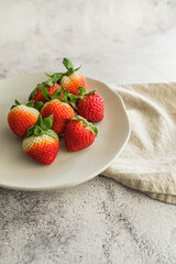 strawberry fresh and juicy fruit on white plate and light background minimalist photo