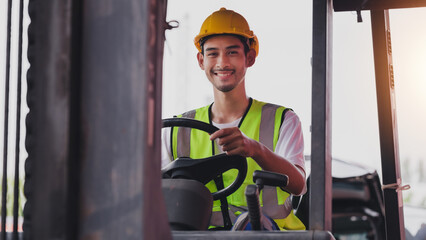 Young Asian work man driving the truck over construction site. Industrial factory worker operating on forklift in the import export shipyard. Foreman at warehouse logistic in Cargo freight ship.