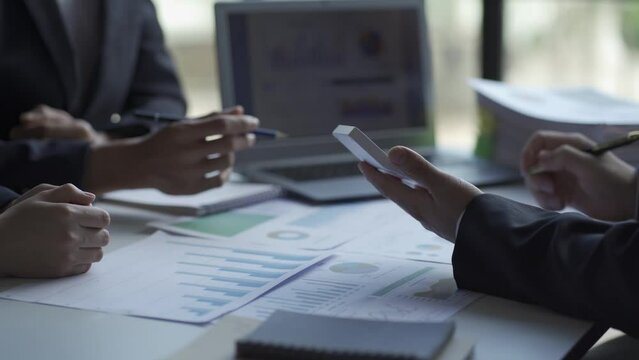 Asian businessman and accountant work at home income and expense record, serious man, using notebook, budget, tax, financial documents work in the financial accounting concept office
 4k