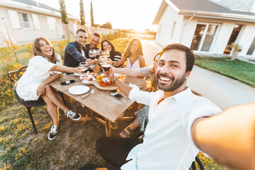 Group of happy friends taking selfie at bbq outdoor dinner in home garden - Multiracial young...