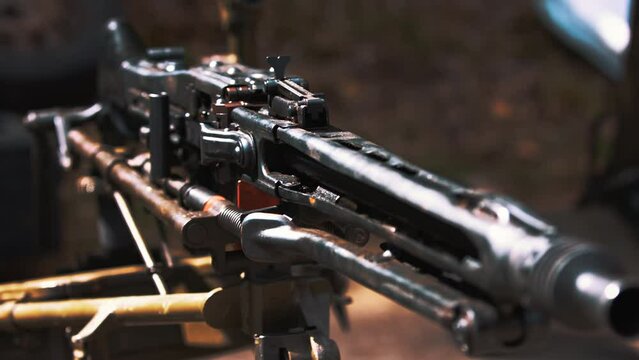 Outdoor closeup slow-motion shot of a Maxim rifle on display rack. Military and shooting range concept. Weapon concept. High quality 4k footage