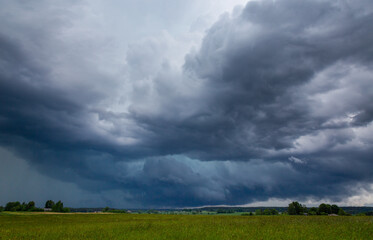 Storm clouds over field, tornadic supercell, extreme weather, dangerous storm