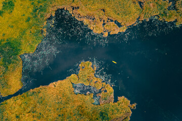 aerial top landscape view green,orance grassland and black lake small kayaking tourist activity relax at rayong botanical garden thailand