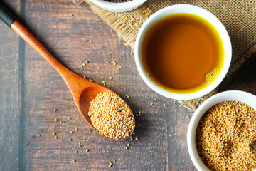Mustard oil and seed on table top view 