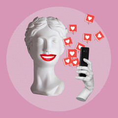 Antique smiling statue's head with red lips holding mobile phone with like symbols from social...