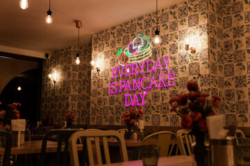 pancake cafe low light neon sign