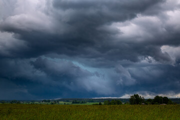 Obraz na płótnie Canvas Storm clouds over field, storm cell, extreme weather, dangerous storm