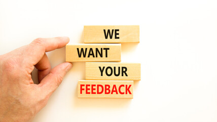 Support and we want your feedback symbol. Concept words We want your feedback on wooden blocks on beautiful white background. Businessman hand. Business, support we want your feedback concept.