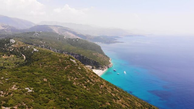 Aerial Drone View of Gjipe Beach and Canyon, Dhermi, Albania - Hidden Paraside with boats, tourists, sunbeds and blue sea