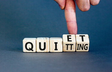 Quiet quitting symbol. Concept words Quiet quitting on wooden cubes. Businessman hand. Beautiful grey table grey background. Business quiet quitting concept. Copy space. - obrazy, fototapety, plakaty