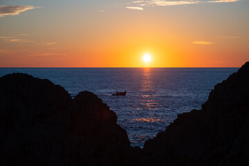 Colorful Capri sunset panorama near lighthouse “Faro“ at west end of famous italian island. Sun...