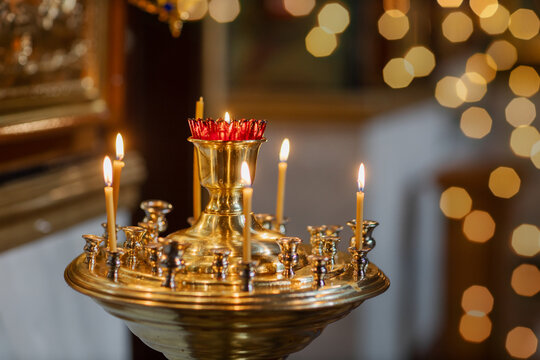 lit wax candles in a Christian church, decoration in the Orthodox Church, symbol of faith and prayer