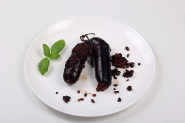 Cracked baked blood sausage on a white,Traditional Latvian blood sausages