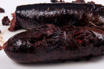 Cracked baked blood sausage on a white,Traditional Latvian blood sausages