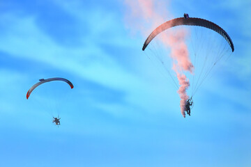 Paraglider flying against the blue sky with clouds, outdoor activities, extreme sports, extreme...