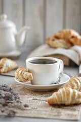 Cup of coffee and croissants. 