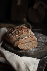 Loaf of homemade bread on wooden table.