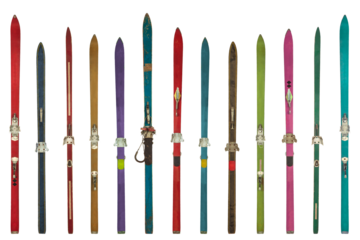 Row of vintage weathered colorful skis