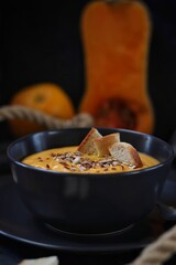 Pumpkin soup with orange juice, croutons and seeds