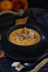 Pumpkin soup with orange juice, croutons and seeds