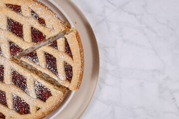 Slice of pie called 'Linzer Torte', a traditional Austrian shortcake pastry topped with fruit...