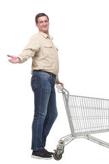 Side view of young man pushing an empty shopping cart