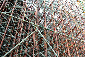 JOHOR, MALAYSIA -JUNE 6, 2022: Metal scaffolding is used as a temporary structure that supports works at the construction site. Also used as a structure for working at height outside the building.

