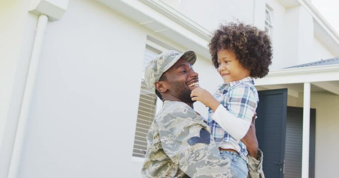 Video of biracial son welcoming african american soldier father