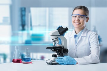 Happy young woman pharmacist mixing reagents at laboratory