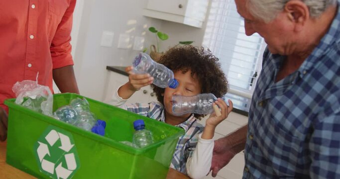 Video of diverse family in the kitchen segregating rubbish - Powered by Adobe