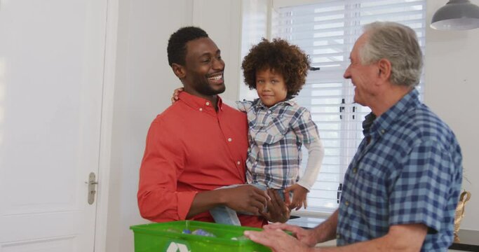 Video of diverse family in the kitchen segregating rubbish - Powered by Adobe