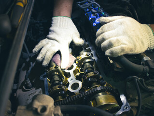 Auto mechanic repairing car. Selective focus.