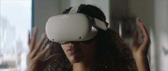 DOLLY IN Attractive African American female puts on a VR virtual reality metaverse headset at home - Powered by Adobe