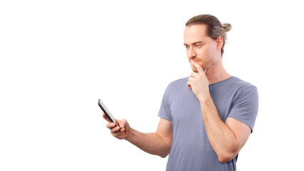 Man looks thoughtfully at his smartphone and rubs his chin. Concept of internet communication, fraud, discretion