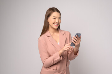 Naklejka premium Young asian woman using smartphone over white background, technology concept. ..