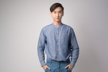 Portrait of young asian man over white background studio.