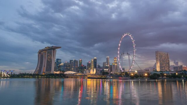 Singapore time lapse 4K, city skyline day to night sunset timelapse at Marina Bay waterfront business district