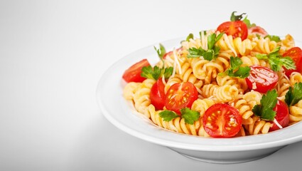 Traditional Italian pasta dish with tomatoes in the plate