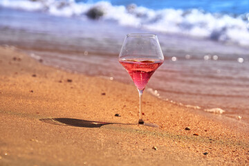 Wine glass with a cocktail by the sea.