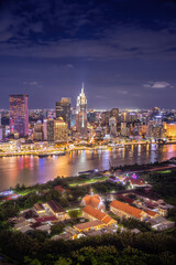 Obraz premium Aerial view view of Ho Chi Minh City skyline and the Saigon River at sunset. Amazing colorful view of skyscraper and other modern buildings at downtown.