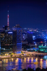 Obraz premium Aerial view of Bitexco Tower, buildings, roads, Thu Thiem 2 bridge and Saigon river in Ho Chi Minh city - Far away is Landmark 81 skyscraper. Travel concept.