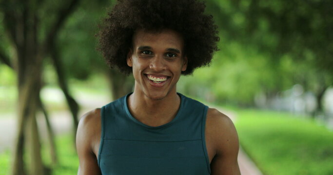 Happy Smiling Young African Man Walking At Park Backwards Looking To Camera