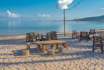 Fototapeta na wymiar table and chairs on the beach