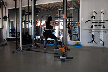 Fototapeta na wymiar Beautiful brunette working out in a gym
